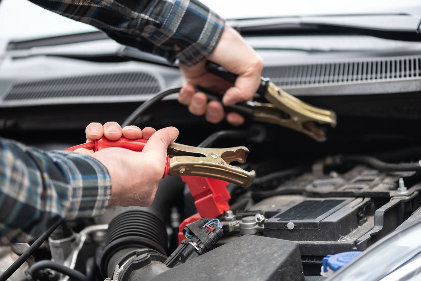 Jumper cables connected to a car battery