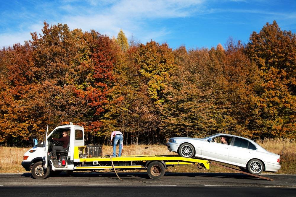 Tow truck loading a car onto a flatbed